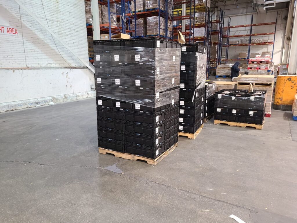 crates stacked on top of each other in warehouse