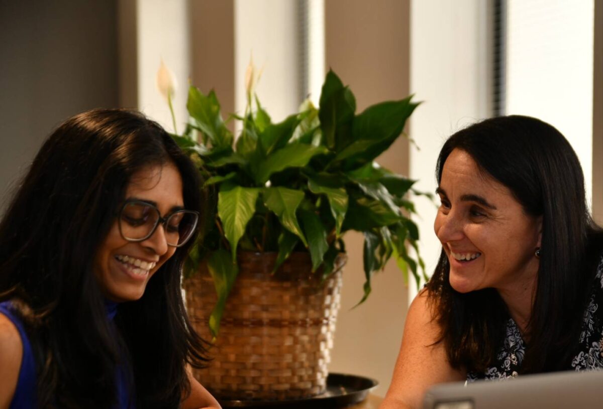 Two employees sit at a desk in an office while working on a project at Tosca's global headquarters in Atlanta, GA.