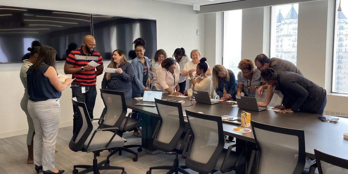 Tosca employees collaborate on a team-building exercise during a professional development session in a conference room at the Tosca Atlanta office.