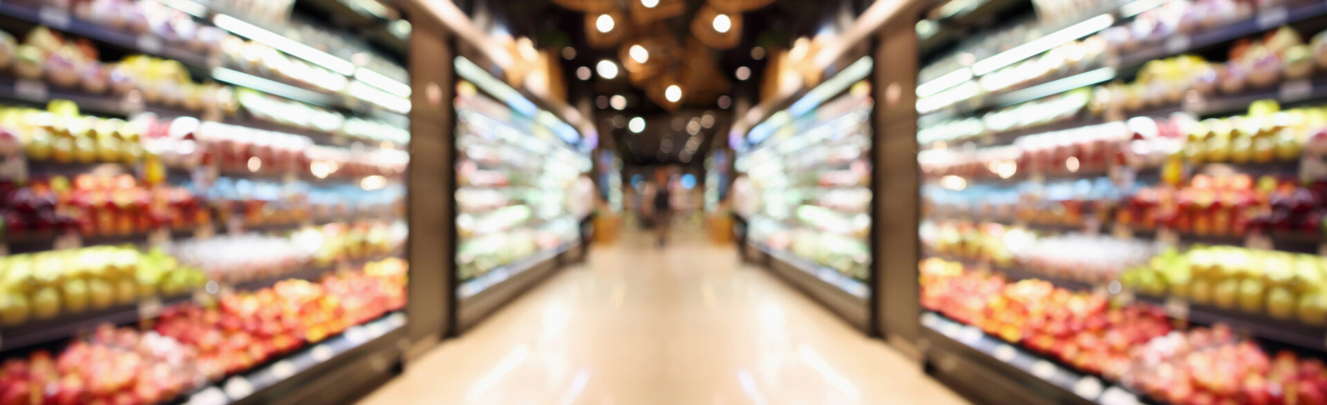 Grocery store shelves with fruits and vegetables blurred background