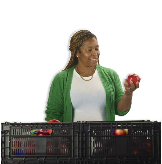 Woman holding an apple from a reusable crate