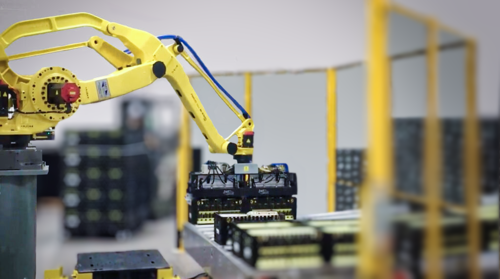 A robotic arm moves Tosca reusable egg crates on a fully automated factory floor.